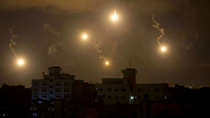Flares lit up the skies over Gaza on Friday night as Israeli troops continued their fight against Hamas