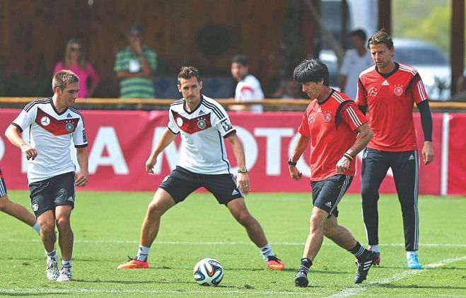 Preparing for the Battle Royale : Germany's (L-R) Philipp Lahm, Miroslav Klose and coach Joachim Loew get into business seriously ahed of their today's semifinal clash at Belo Horizonte. PHOTOS: GETTY IMAGES
