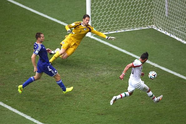Reza Ghoochannejhad of Iran shoots and scores his team's first goal past goalkeeper Asmir Begovic of Bosnia and Herzegovina during the 2014 FIFA World Cup Brazil Group F match between Bosnia and Herzegovina and Iran at Arena Fonte Nova on June 25, 2014 in Salvador, Brazil. Photo: Getty Images