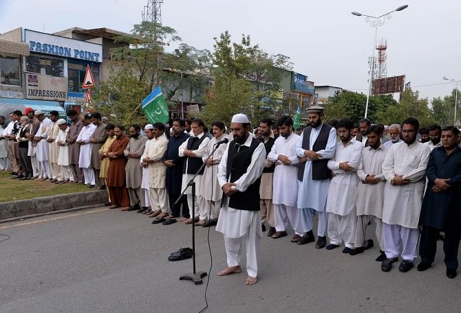 Pakistani supporters of religious party Jamaat-e-Islami offer in absentia funeral prayers for former Bangladeshi politician Ghulam Azam in Islamabad, yesterday.  Photo: AFP