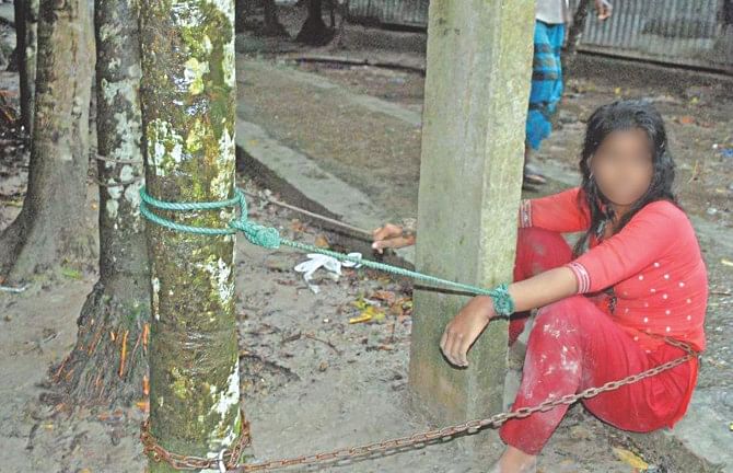 For 11 hours this 18-year-old girl was chained out in the open overnight allegedly by her boyfriend and his parents in Barisal city while no passers-by or neighbour came to her assistance. The girl had refused to withdraw cases accusing the boyfriend of raping her and trying to engage her into prostitution. The girl was rescued on Tuesday morning. Her face has been blurred to protect her identity. Photo: Star
