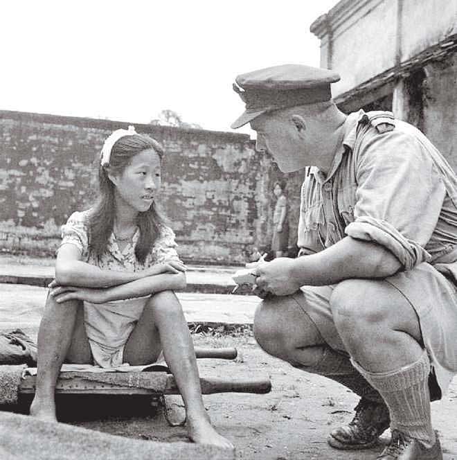 A young ethnic Chinese woman who was in one of the Imperial  Japanese Army's "comfort battalions" is interviewed by an Allied  officer. Rangoon, Burma. August 8, 1945.  Photo Courtesy: Wikipedia