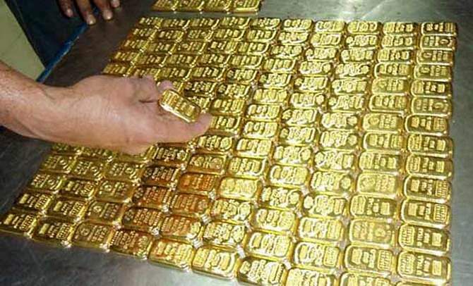In this November 11 file photo, customs officials display smuggled 320 gold bars that seized at a Biman flight from Dubai at Shahjalal International Airport. 