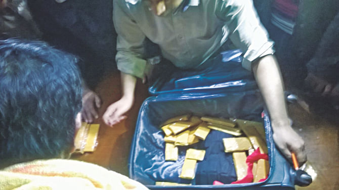 The gold bars being taken out of a suitcase.  Photo: Akram Hosen