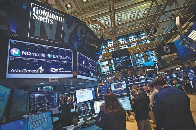 The Goldman Sachs logo is pictured on their post as traders work on the floor of the New York Stock Exchange in New York. Photo: REUTERS 