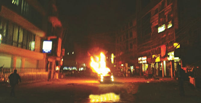 The car of BNP chairperson's adviser Reaz Rahman in flames near Westin Hotel in the city's Gulshan area after gunmen attacked him last night. Photo: Collected