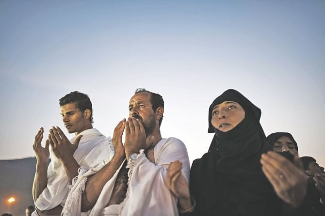 Muslim pilgrims pray as they join one of the hajj rituals on Mount Arafat near Makkah yesterday. Photo: AFP