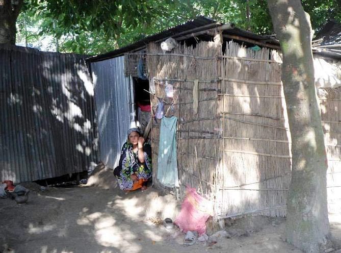 Hapless Salma Begum, living on the Nilkuthi flood control dyke in Phulchhari upazila of Gaibandha with two daughters and mother, gives a bleak look while sitting at the door of her makeshift hut. PHOTO: STAR