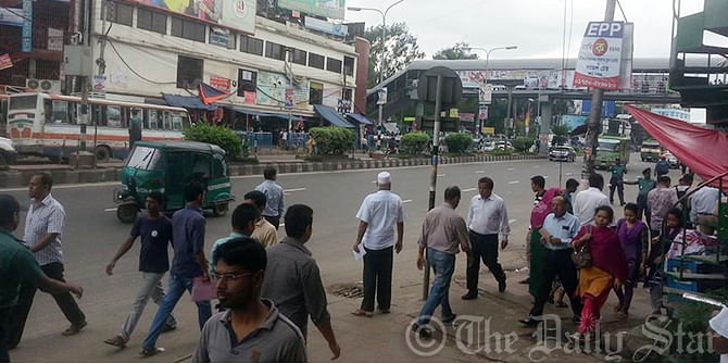 Office going people wait for vehicles on Kazi Nazrul Islam Avenue in capital's Farmgate area, which used to be a busy neighbourhood during working days, during eight-hour shutdown called by Chhatra Sena on Sunday. Photo: SAM Jahan/STAR