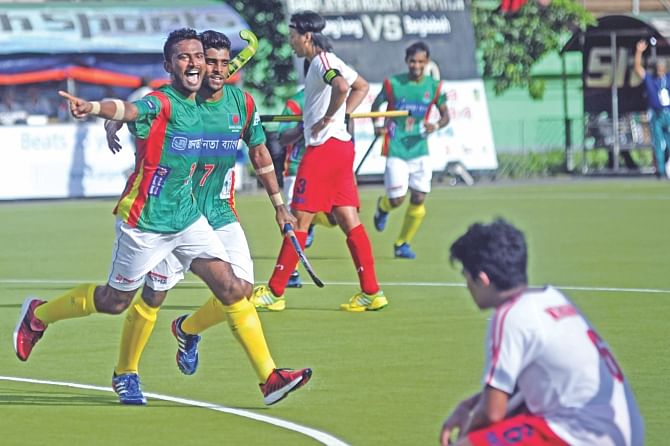 Bangladesh forward Hasan Jubair Niloy (L) celebrates one of his three goals against Hong Kong during their first round match of the Hockey World League at the Maulana Bhasani Hockey Stadium yesterday. PHOTO: STAR