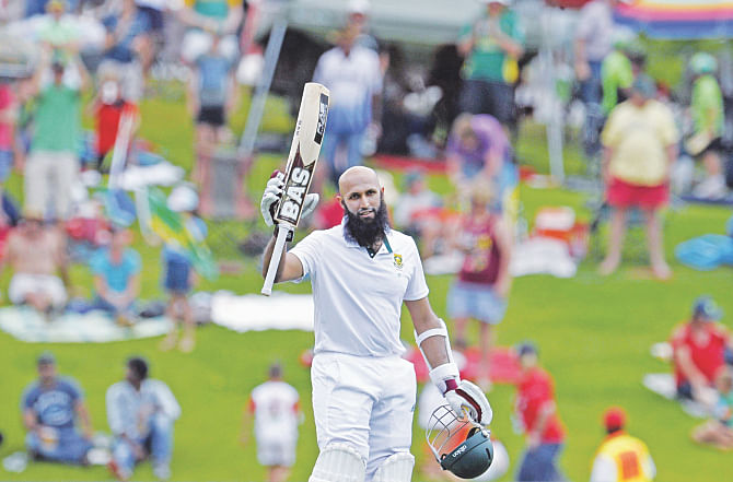 South Africa captain Hashim Amla raises his bat to celebrate his double century on the second day of the first Test against West Indies at SuperSport Park in Centurion yesterday. PHOTO: AFP