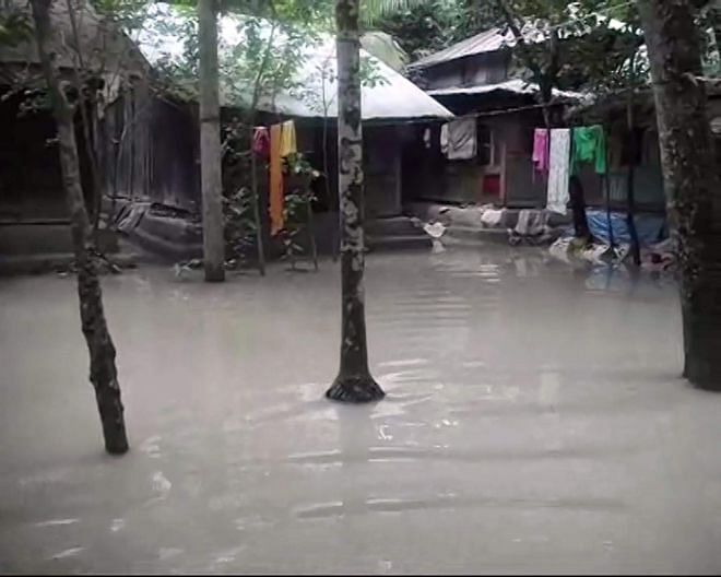 Flood water has submerged the yard of a homestead at Hazariganj village in Charfashion upazila of Bhola district.  Photo: Star