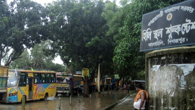 Flash flood in Hili town in Hakimpur upazila of Dinajpur district disrupted activities at the land port there for the last couple of days. PHOTO: STAR