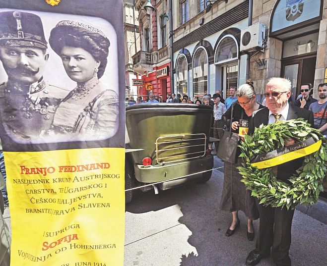 People lay a wreath at the historical street corner where Gavrilo Princip assassinated Austro-Hungarian heir to the throne Archduke Franz Ferdinand and his wife Sofia in Sarajevo, during ceremonies commemorating the 100th anniversary of their assassination, yesterday. Photo: AFP