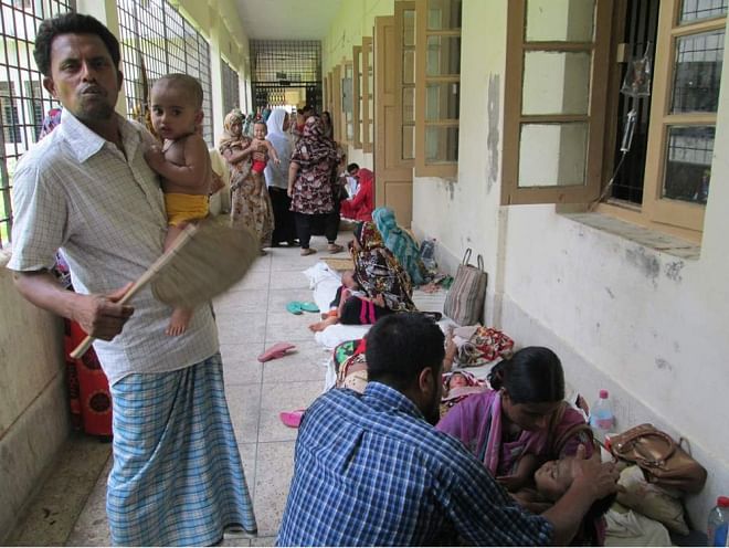 PICTURE TELLS THE TALE: Quite a few child patients are kept on the veranda of Pirojpur Sadar Hospital as its Children's Ward fails to accommodate the increasing number of treatment seekers, amid the ongoing hot spell. The photo was taken on Tuesday noon. PHOTO: STAR