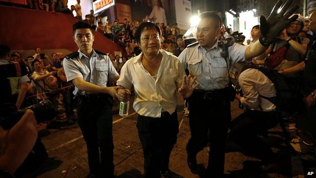 Hong Kong police arrest an activist from the road. Photo: AP