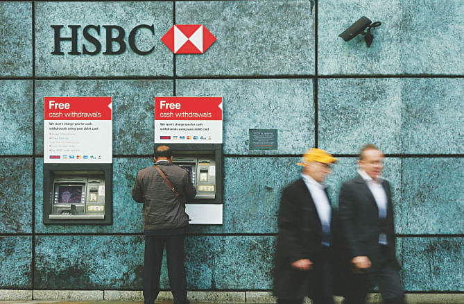 People walk past an HSBC bank branch in the City of London yesterday.  Photo: REUTERS 