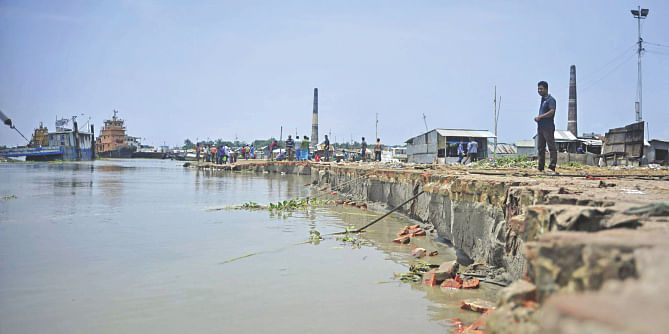 This photo taken recently shows the mighty Padma gobbling up its shores at Mawa in Munshiganj disrupting ferry services and destroying approach roads to pontoons. The erosion here is just the tip of the iceberg. Photo: Firoz Ahmed