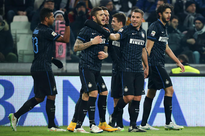 Inter Milan forward Mauro Icardi (2nd from L) celebrates his equalising goal with teammates during their Serie A clash  against Juventus in Turin on Tuesday. Photo: AFP