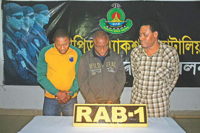 Rab places before the media three foreigners arrested yesterday in the capital's Uttara for illegally staying in Bangladesh. Photo: courtesy