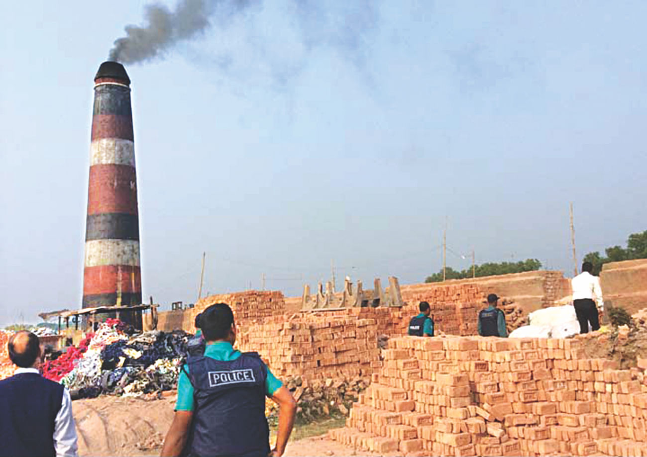 A mobile court of Chittagong district administration conducts a drive in Kattali of Chittagong city yesterday to fine two brick kilns operating there without licences and environment clearance certificates.  Photo: Star