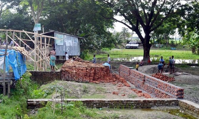 Illegal construction of a market on a government land at Baliatali in Kalapara upazila under Patuakhali district goes on by three brothers, also local activists of the ruling party. PHOTO: STAR