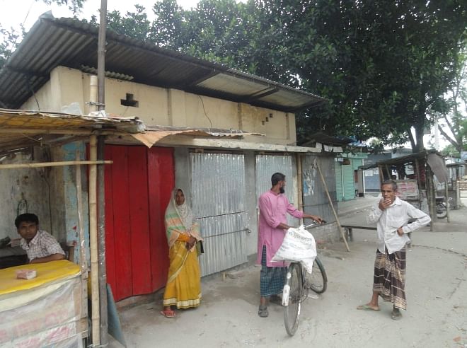 Three illegally built shops make this shed, meant for waiting bus passengers on Lalmonirhat-Burimari road at Milon Bazar in Hatibandha upazila under Lalmonirhat district, virtually unusable for the beneficiaries, thanks to the political clout of a local Awami League leader. PHOTO: STAR