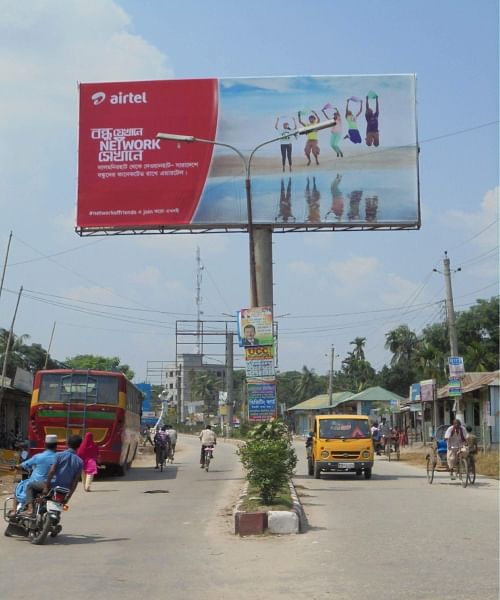 Three illegal billboards, set up on Lalmonirhat- Burimari highway at Mission Intersection in Lalmonirhat town, pose risk of accident anytime. Photo: Star