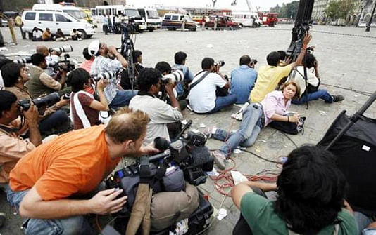 Photographers and members of the media cover a gunfire at the Taj Hotel in Mumbai November 28, 2008. Photo: Reuters