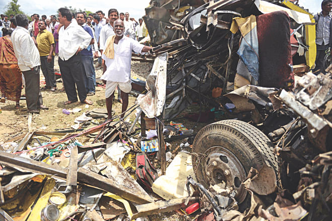 The wreckage of the bus and the train. The passenger train rammed into the school bus in southern India, killing 25 children, officials said.  Photo:AFP