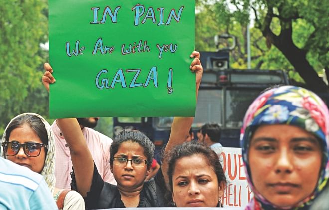Indian protestors hold placards as they take part in a rally against Israeli attacks on Gaza in New Delhi, yesterday. Photo: AFP 