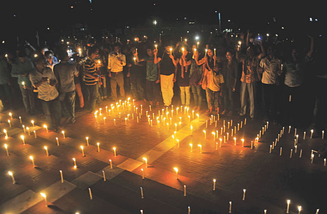 A multi-ethnic crowd of Bangladeshis hold a vigil of thousand candles at Central Shaheed Minar in the capital yesterday marking International Day of the World's Indigenous Peoples today, demanding that the indigenous communities of the country be constitutionally recognised as Adivasis, organised by Garo Student Union. Photo: Star