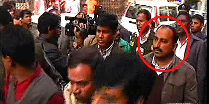 Law enforcers take Ahmed Atique, the diplomatic correspondent of the Bangla daily Inqilab, to a court in the capital in January. Atique was placed on a two-day remand today while his two colleagues, news editor and deputy chief reporter, were denied bail in a case filed for publishing false report on participation of Indian troops in Satkhira drive.
