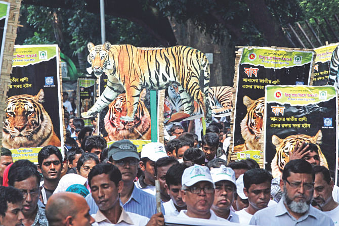 Bangladesh Forest Department brings out a colourful procession at Doyel Chattar on Dhaka University campus yesterday marking International Tiger Day 2014, which is usually observed on July 29.  Photo: Palash Khan