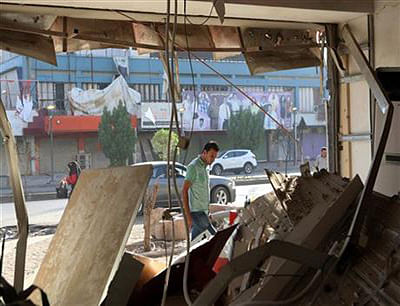 An Iraqi man inspects the site of a car bomb on Saadoun street in Baghdad, Iraq,  September. 5, 2014. The bomb exploded in a commercial area in central Baghdad on Tuesday night, killing and wounding civilians. Photo: AP
