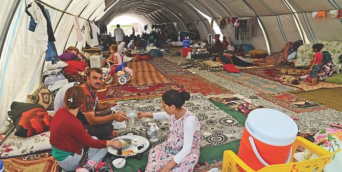 Displaced Iraqi people from the Yazidi community take refuge in a camp near the Turkey-Iraq border at Silopi in Sirnak yesterday. Photo: AFP