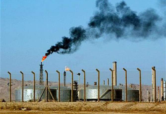 In this AP file photo taken on Monday, October 6, 2003, an oil refinery is seen in the city of Beiji, home to Iraq's largest oil refinery where Islamic militants laid siege to late Tuesday night, threatening a facility key to the country's domestic supplies as part of their ongoing lightning offensive across the country