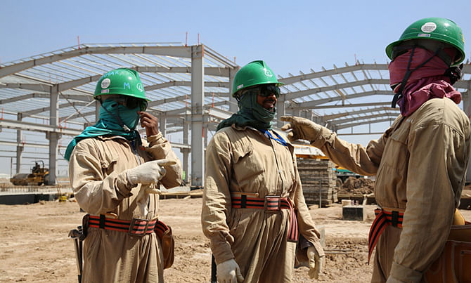 In this undated file photo, workers are seen busy at a national housing programme project called Bismaya   New City Project in Baghdad of Iraq.