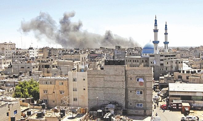 Smoke billows from a building hit by an Israeli air strike in the town of Rafah, in the southern Gaza Strip, yesterday. The Arab League has called on the international  community to end Israeli air strikes on Gaza and to protect Palestinians, ahead of a foreign ministers' meeting yesterday. Photo: AFP