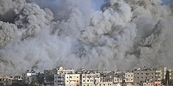 Smoke and debris fill the air during an Israeli strike on Gaza City early yesterday.  Photo: AFP
