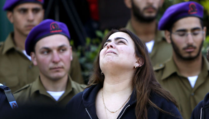 An Israeli woman grieves during the funeral of 25-year-old Israeli army Captain Yochai Kalangel at the Mount Herzl military cemetery in Jerusalem, yesterday.  Photo: AFP