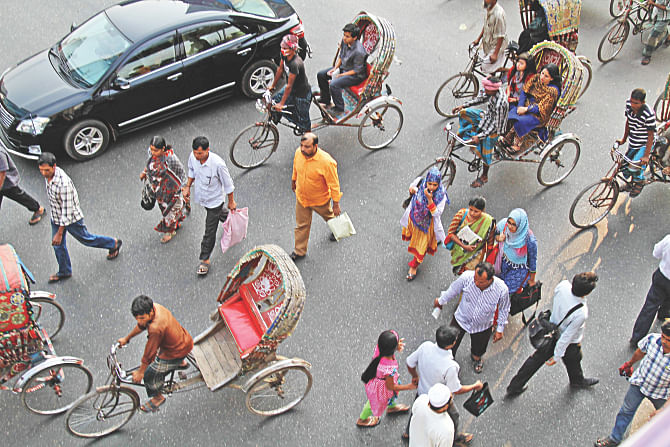 Pedestrians caring little about the danger they are putting themselves into and the motorists on Dhaka streets. They have little regard for the facilities in place for them, as seen in the photo taken from the footbridge at Bangla Motor intersection. Photo: Sk Enamul Haq /Anisur Rahman