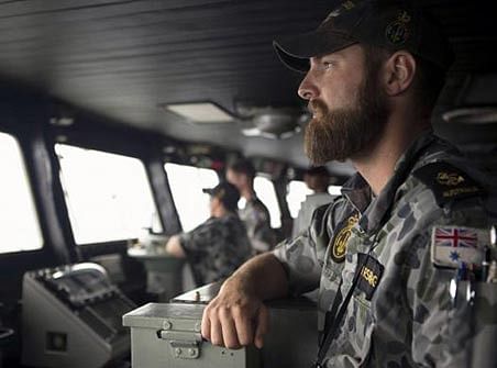 Leading Seaman Luke Horsburgh stands watch during his duty as Quartermaster on the bridge of the Australian Navy ship HMAS Success after it arrived in the search area for missing Malaysian Airlines flight MH370 in this picture released by the Australian Defence Force on March 23.Photo: Reuters 