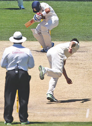 The batsman is struck on the helmet by a Mitchell Johnson bouncer. PHOTOS: AFP