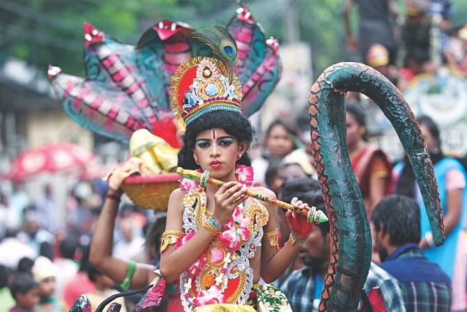 A boy dressed as Lord Krishna takes part in a procession on Janmashtami, a religious festival marking the birthday of the Hindu god, at Palashi intersection in the capital yesterday.    Photo: Star