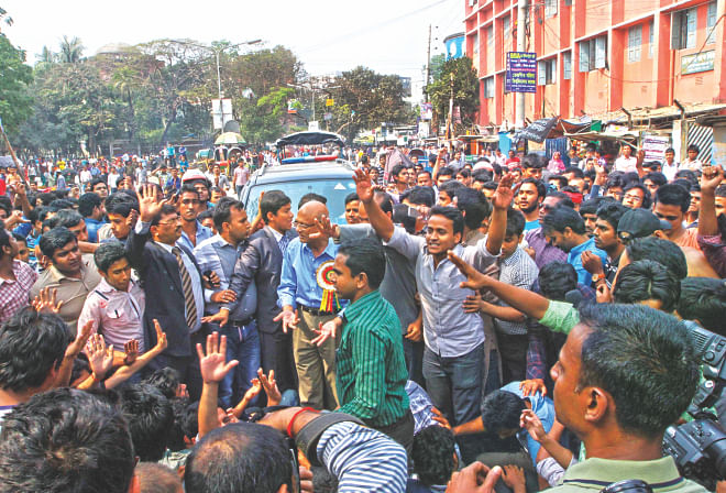 Education Minister Nurul Islam Nahid tries to calm down the agitating students of Jagannath University after they stop the minister's motorcade near the university demanding the buildings they used to use as dorms be returned to them. Photo: Palash Khan