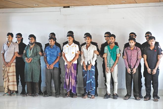 Eight persons arrested in connection with the February Trishal ambush to free three convicted militants are paraded before the media at Uttara Rab headquarters yesterday.   Photo: Star