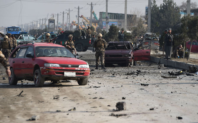 Afghan intelligence personnel inspect the site of a suicide attack on a British embassy vehicle along the Kabul-Jalalabad road in Kabul, yesterday. Photo: AFP