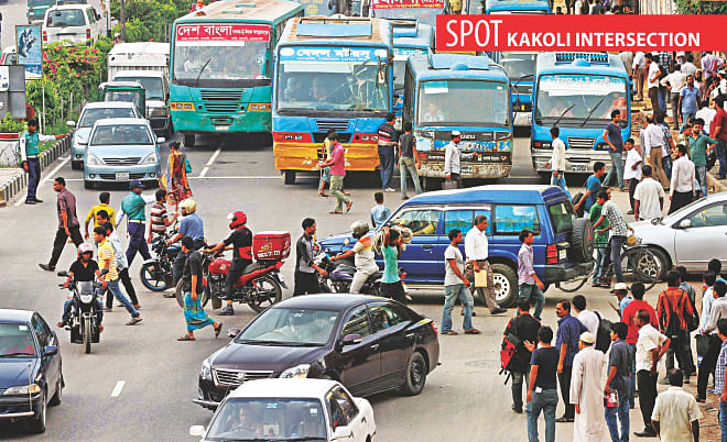Cars and bikes, from the right side of the intersection, move ahead even though a traffic policeman signals them to wait. The photo was taken at the capital's Kakoli around 6:00pm yesterday.     Photo: Sk Enamul Haq