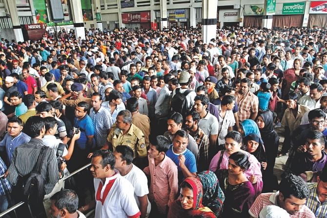 People queue up at the ticket counters of Kamalapur Railway Station in Dhaka yesterday to buy tickets home for their Eid holidays. Photo: Anisur Rahman